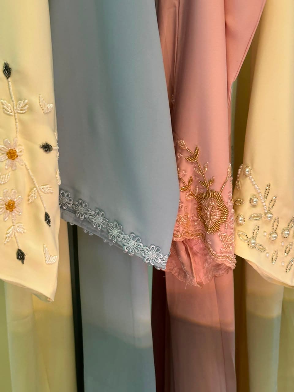 HOOR abaya cuff embroidery detail — daisy and gold beads